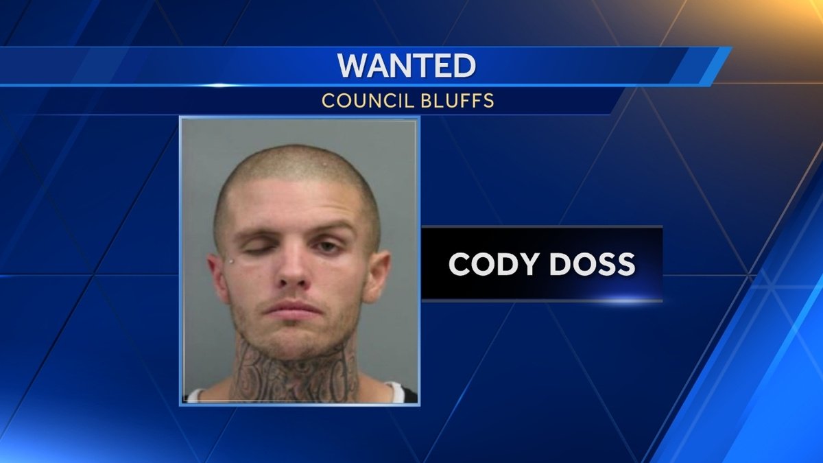 Council Bluffs police identified a suspect wanted for dragging an officer nearly 30 feet with an SUV Tuesday morning. Cody Doss, 24, of Council Bluffs, was already wanted on warrants before the incident, police said. Doss tried to drive away from an officer near 36th and Avenue G, when the officer's hand became stuck in the door, police said.