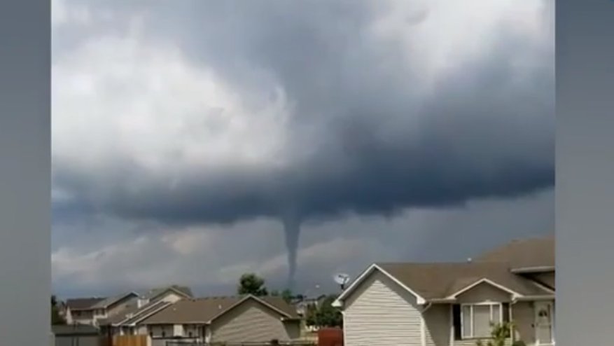 Tornado damage in Bondurant, Iowa, while another funnel cloud raced nearby.
